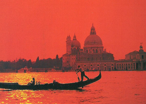Venice waterfront and gondola at a Mediterranean sunset